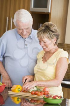 Royalty Free Photo of a Husband and Wife Cutting Vegetables