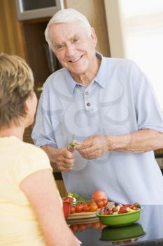 Royalty Free Photo of a Husband and Wife Preparing Vegetables