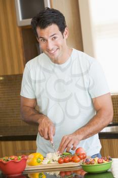 Royalty Free Photo of a Man Cutting Vegetables
