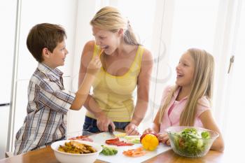 Royalty Free Photo of a Mother and Children Preparing Food