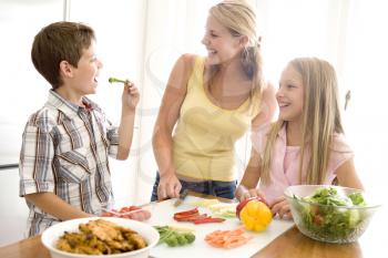 Royalty Free Photo of a Mother and Children Preparing Food