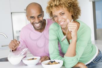 Royalty Free Photo of a Man and Woman Eating Breakfast