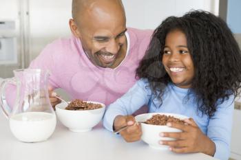 Royalty Free Photo of a Father and Daughter Having Breakfast