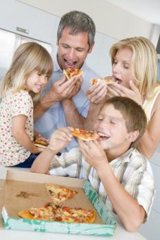 Royalty Free Photo of a Family Having Pizza