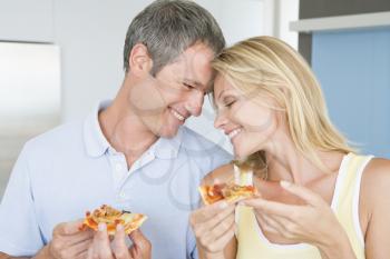 Royalty Free Photo of a Husband and Wife Eating Pizza