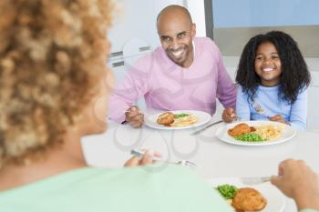 Royalty Free Photo of a Family Eating a Meal