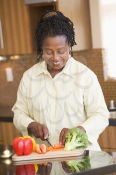 Royalty Free Photo of a Woman Chopping Vegetables