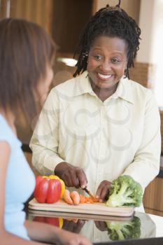 Royalty Free Photo of a Mother and Daughter Preparing Food