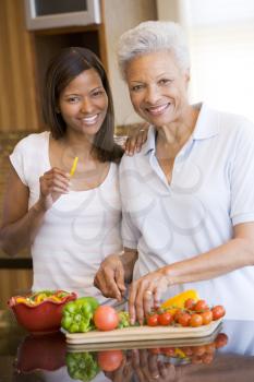 Royalty Free Photo of a Mother and Daughter Preparing Vegetables