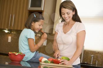 Royalty Free Photo of a Mother and Daughter Preparing Vegetables