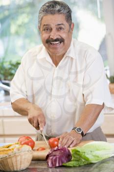 Royalty Free Photo of a Man Chopping Vegetables
