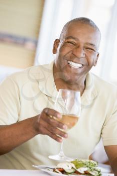 Royalty Free Photo of a Man Having a Glass of Wine With Dinner