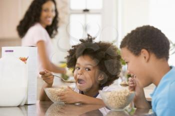 Royalty Free Photo of Children Having Breakfast With Mom in the Kitchen
