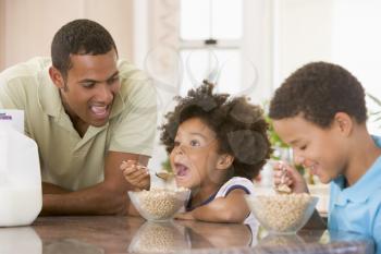 Royalty Free Photo of Children Having Breakfast With Dad