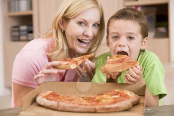 Royalty Free Photo of a Mother and Son Eating Pizza