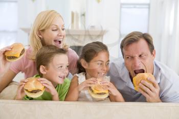 Royalty Free Photo of a Family Eating Cheeseburgers