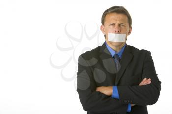 Royalty Free Photo of a Man in a Suit With His Mouth Taped