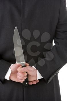 Royalty Free Photo of a Man With a Knife Behind His Back