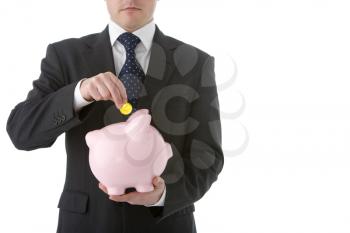 Royalty Free Photo of a Businessperson Putting a Coin in a Bank