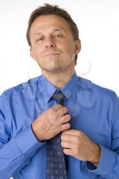Royalty Free Photo of a Man Adjusting His Tie