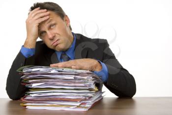 Royalty Free Photo of a Man Overwhelmed by Paperwork