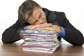 Royalty Free Photo of a Businessman Asleep on Paperwork