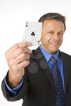 Royalty Free Photo of a Man Holding an Ace of Clubs