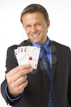 Royalty Free Photo of a Man Holding Four Aces