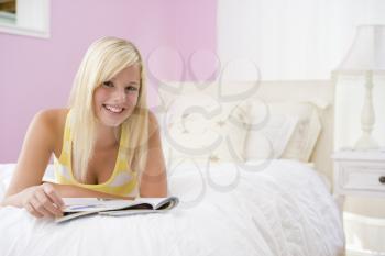 Royalty Free Photo of a Girl Reading in Her Room