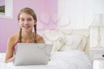 Royalty Free Photo of a Girl in Her Room With a Laptop
