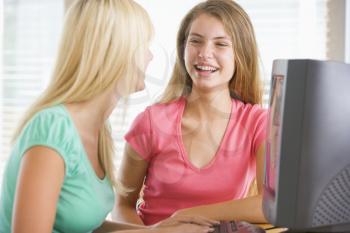 Royalty Free Photo of Two Girls Using a Computer