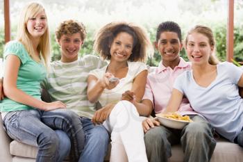 Royalty Free Photo of a Group of Teens Eating Potato Chips