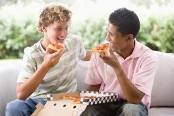 Royalty Free Photo of Boys Eating Pizza