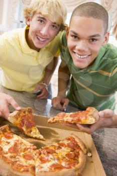 Royalty Free Photo of Boys Eating Pizzas