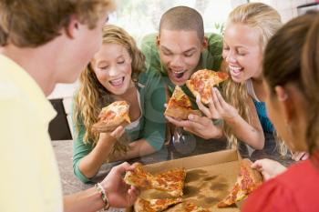 Royalty Free Photo of Girls and Boys Eating Pizza