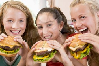 Royalty Free Photo of Teens Eating Burgers