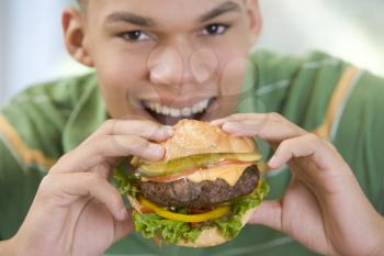 Royalty Free Photo of a Boy Eating a Burger