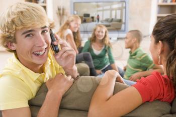 Royalty Free Photo of Teens and One on a Cellphone