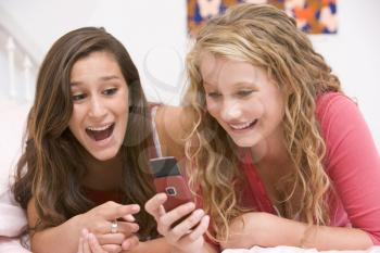 Royalty Free Photo of Two Girls Using a Cellphone