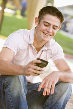 Royalty Free Photo of a Boy With a Cellphone