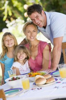 Royalty Free Photo of a Family Enjoying Supper Outside