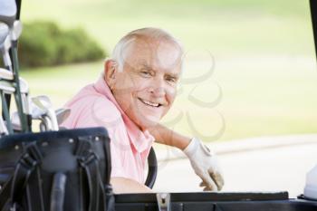 Royalty Free Photo of a Male in a Golf Cart