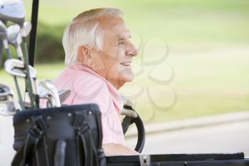 Royalty Free Photo of a Male in a Golf Cart