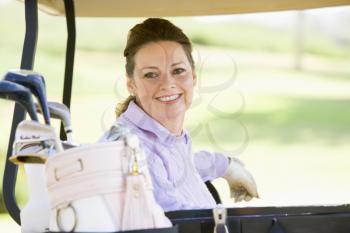 Royalty Free Photo of a Woman in a Golf Cart