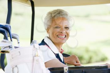 Royalty Free Photo of a Woman in a Golf Cart