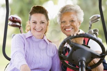Royalty Free Photo of Two Women in a Golf Cart