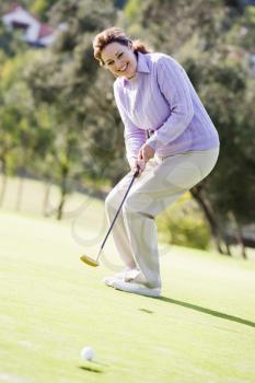 Royalty Free Photo of a Woman Golfing