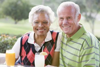 Royalty Free Photo of a Couple Having a Drink at a Golf Course