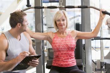 Royalty Free Photo of a Woman Working Out With a Personal Trainer
