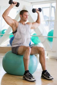 Royalty Free Photo of a Man Working Out at a Gym